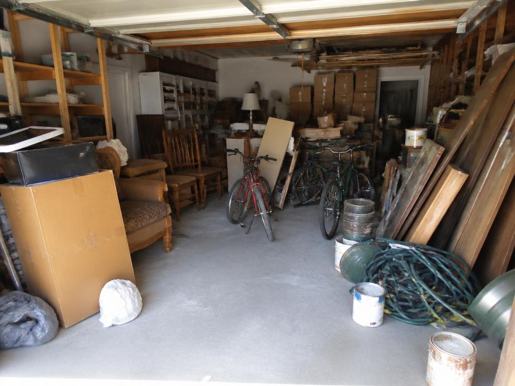 Two-car garage cleanout before JDC Junk Removal arrived